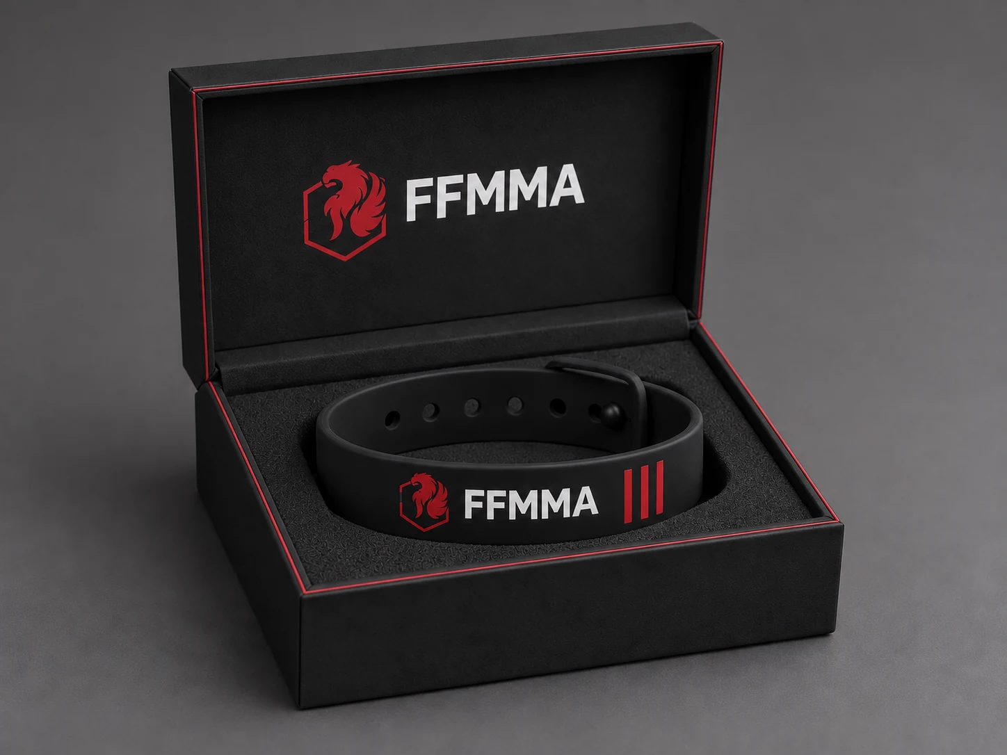 Presentation box and black adjustable bracelet with the red FFMMA emblem, shown as a studio product concept.
